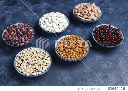 Legumes and beans assortment in different bowls on light stone background . Top view. Healthy vegan protein food. 63940426