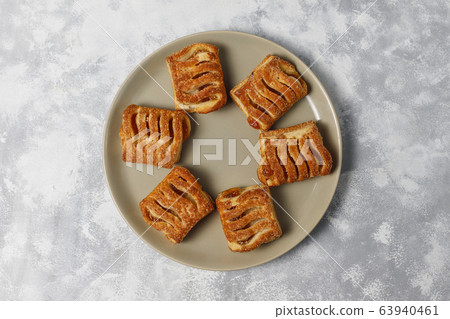 Puff pastry cookies filled with Apple jam and fresh red apples on light concrete background Puff pastry cookies filled with Apple jam and fresh red apples on light concrete background 63940461