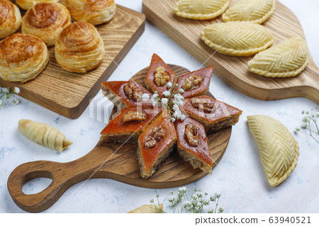 Traditional Azerbaijan sweets shakarbura,bakhlava,qogal,mutaki cookies on light background,Azerbaijan holiday Novruz background. 63940521