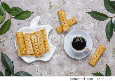 Apple puff pastry cookies in apple shape plate with fresh apples ,top view Apple puff pastry cookies in apple shape plate with fresh apples ,top view 63940998