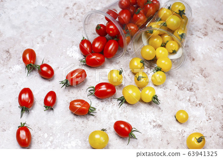 Cherry tomatoes of various colors,yellow and red cherry tomatoes on light background Cherry tomatoes of various colors,yellow and red cherry tomatoes on light background 63941325
