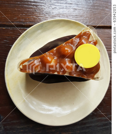 a slice of Macadamia pistachio and almond nuts cake serving with cocoa powder and yellow sweet sugar plate on circle ceramic tray on dark brown table at coffee gourmet cafe, graphic design component, a slice of Macadamia pistachio and almond nuts cake serving with cocoa powder and yellow sweet sugar plate on circle ceramic tray on dark brown table at coffee gourmet cafe, graphic design component, 63942053
