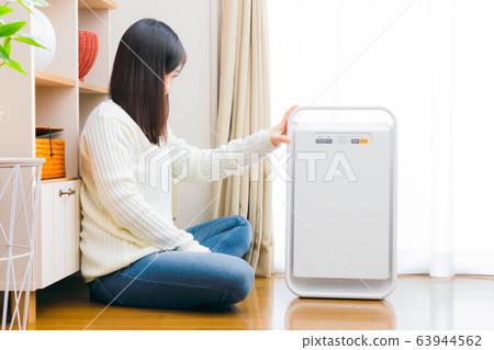Air purifier woman copy space 63944562