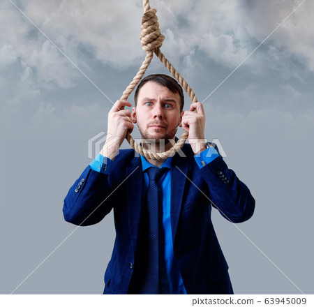 Depressed businessman wearing rope loop committing suicide. 63945009
