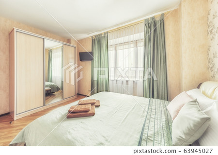 Cozy bright bedroom with closet and window 63945027