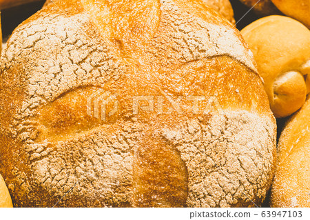 Fresh baked bread with a golden crust, loaf, buns, white, rye on a rustic wooden background with sil rustic. Flat layout 63947103