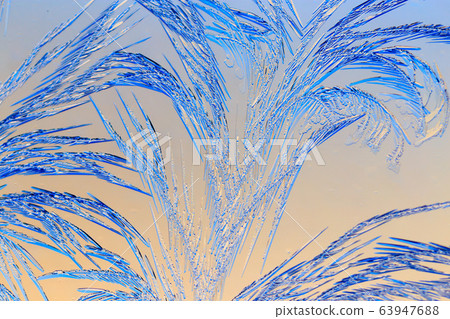 Natural pattern on glass at dawn of the sun. 63947688
