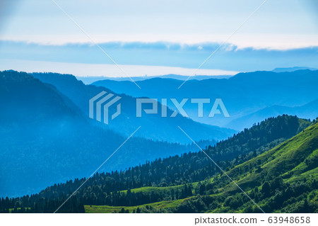 View over the Green Valley, surrounded by high mountains 63948658
