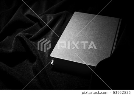 Hardcover book on dark background Hardcover book on dark background 63952825