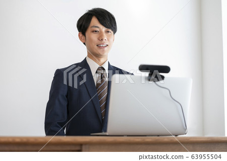 Young man receiving an online interview using a webcam Young man receiving an online interview using a webcam 63955504