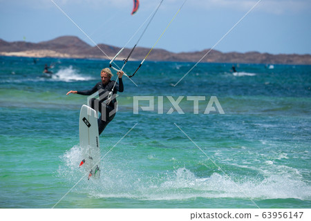 The kite surfer rides the waves of the Atlantic Ocean The kite surfer rides the waves of the Atlantic Ocean 63956147