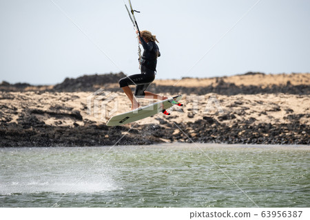 The kite surfer rides the waves of the Atlantic Ocean 63956387