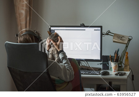 girl working from home with her cat 63956527