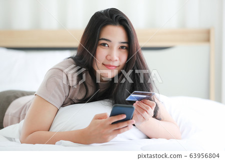Woman using fake credit card. 63956804