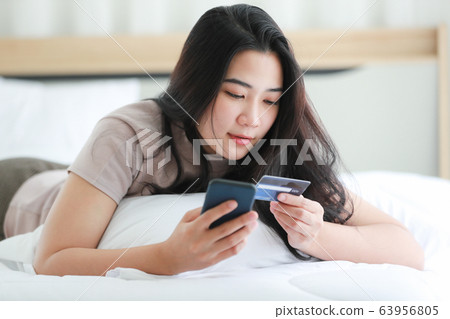 Woman using fake credit card. 63956805