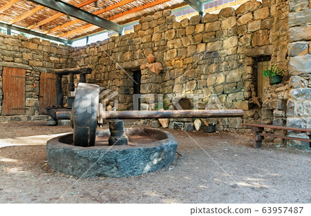 The old press for crushing olive oil The old press for crushing olive oil 63957487