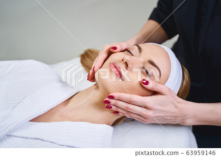 Happy woman enjoying beauty procedures stock photo 63959146