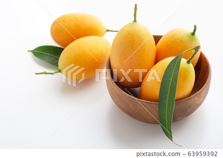 Marian plum, plum mango in wooden bowl 63959392