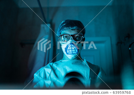Young male researcher carrying out scientific experiment. Young male researcher carrying out scientific experiment. 63959768