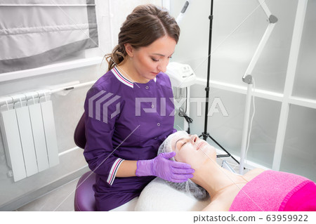 Relaxed woman with a deep cleansing nourishing face mask applied to her face. Spa treatment Relaxed woman with a deep cleansing nourishing face mask applied to her face. Spa treatment 63959922