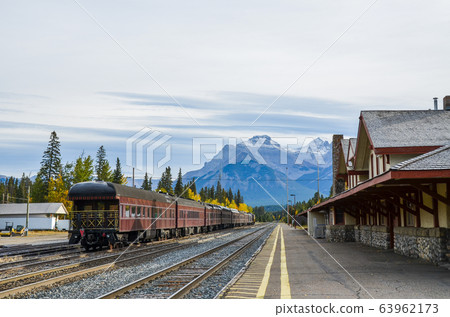 Autumn Canadian Rockies: Old Trains and Mountain Cascades at Banff Station in Yellow Leaves (Banff National Park, Canada) 63962173