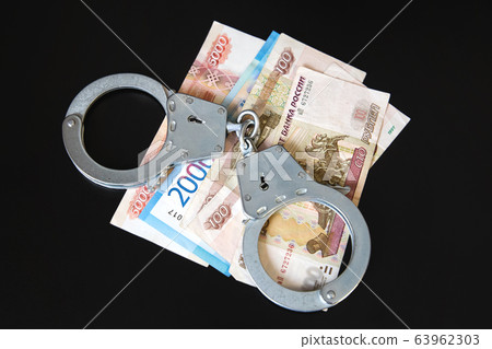 Money and handcuffs. Criminal punishment for a 63962303