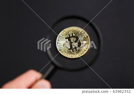 coin bitcoin under a magnifying glass 63962352