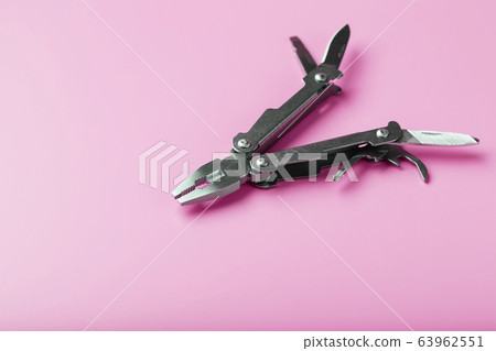 Multitool is a multi-functional tool on a pink 63962551
