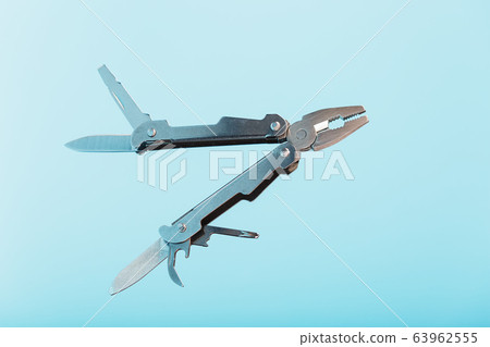 The multitool multi-function tool hovers on a blue 63962555