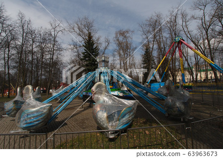 Carousels closed due coronavirus COVID-19 quarantine in the city park with nobody, all people at home 63963673