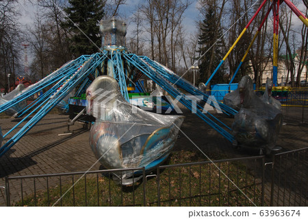 Carousels closed due coronavirus COVID-19 quarantine in the city park with nobody, all people at home 63963674