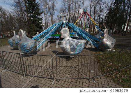 Carousels closed due coronavirus COVID-19 quarantine in the city park with nobody, all people at home 63963679