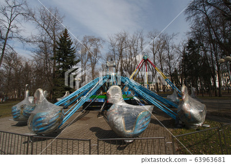 Carousels closed due coronavirus COVID-19 quarantine in the city park with nobody, all people at home 63963681