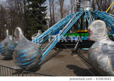 Carousels closed due coronavirus COVID-19 quarantine in the city park with nobody, all people at home 63963683