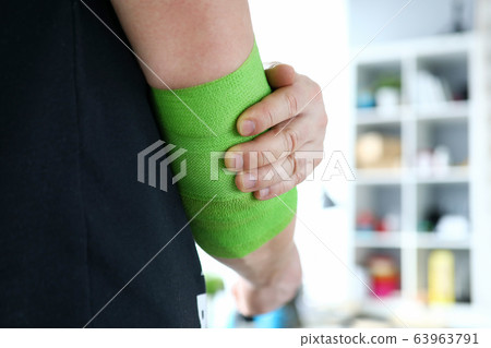 Athlete holding on elbow 63963791