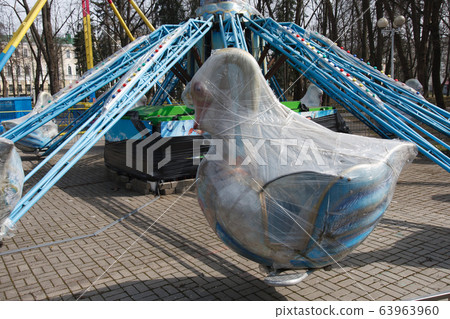 Carousels closed due coronavirus COVID-19 quarantine in the city park with nobody, all people at home 63963960