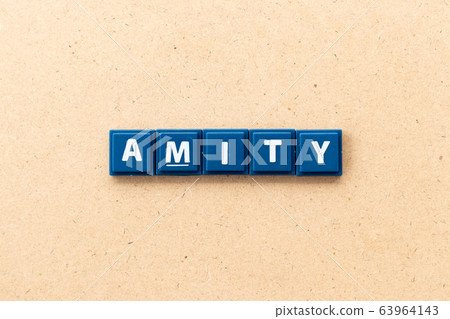 Tile letter in word amity on wood background Tile letter in word amity on wood background 63964143