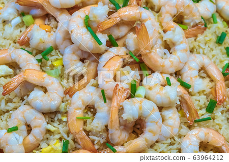 Shrimp fried rice and soy sauce with shrimp on top in the pan to make it look appetizing at the local market. 63964212