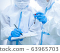 Woman doctor wearing mask and holding test tube 63965703