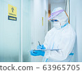 Asian doctor in personal protective suit wearing 63965705