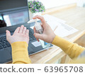Asian women work at home using notebook, pressing 63965708