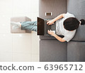 Beautiful Asian women work at home using notebook 63965712