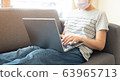 Beautiful Asian women work at home using notebook 63965713