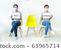Asian women wearing masks holding signs with text 63965714