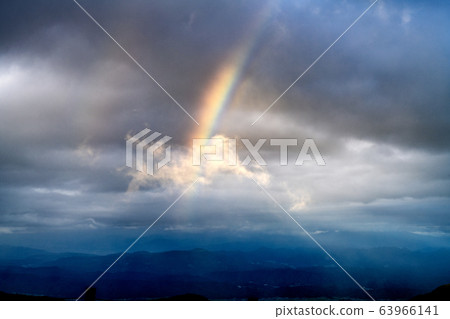 Rainbow over a plain overlooking from the summit Rainbow over a plain overlooking from the summit 63966141