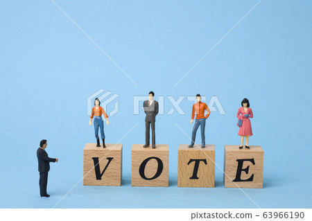 Miniature people voting Miniature people voting 63966190