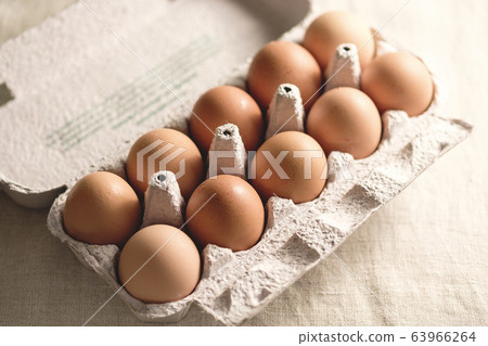 Top down on a cardboard carton of fresh eggs Top down on a cardboard carton of fresh eggs 63966264