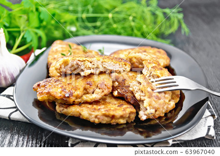 Fritters meat in black plate on board 63967040
