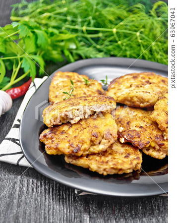 Fritters meat in black plate on dark board 63967041