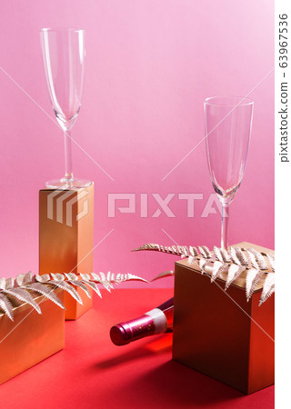 Bottle of rose wine and flutes, golden branches Bottle of rose wine and flutes, golden branches 63967536